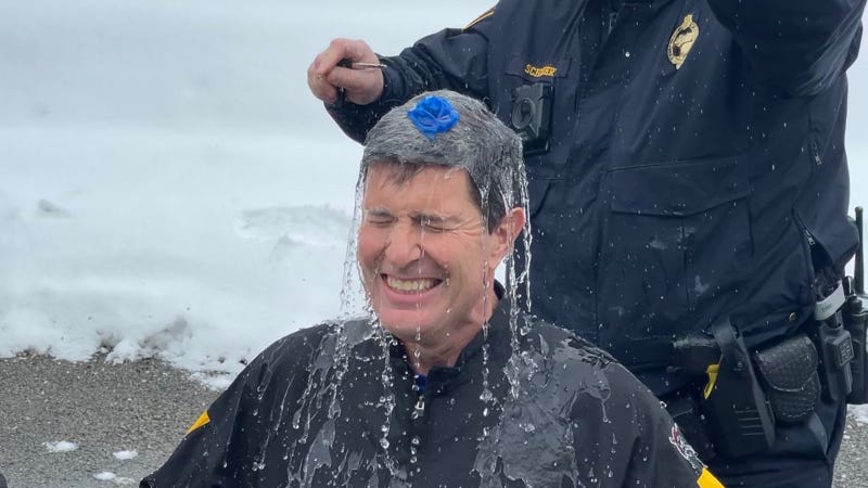 Pittsburgh Police Chief Scott Schubert pops balloon full of cold water over Rick Dayton's head in Polar Pop Challenge