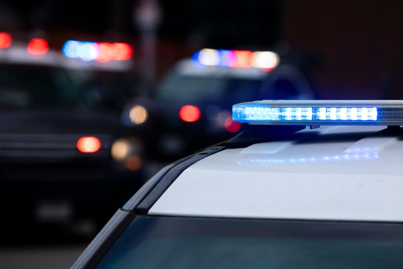 Police squads converge on a crime scene
