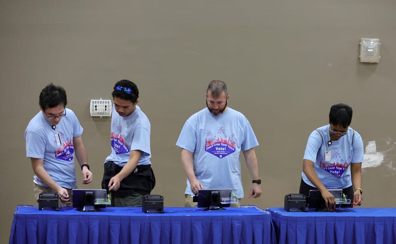 Election workers set up machines