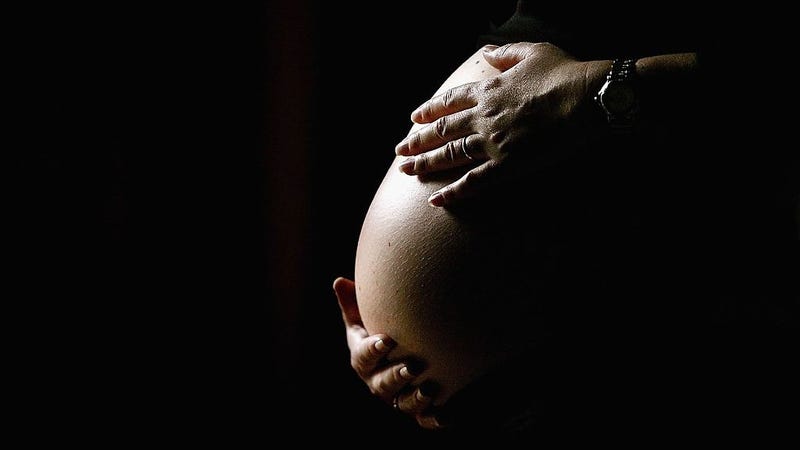 A pregnant woman holds her stomach June 7, 2006 in Sydney, Australia. 