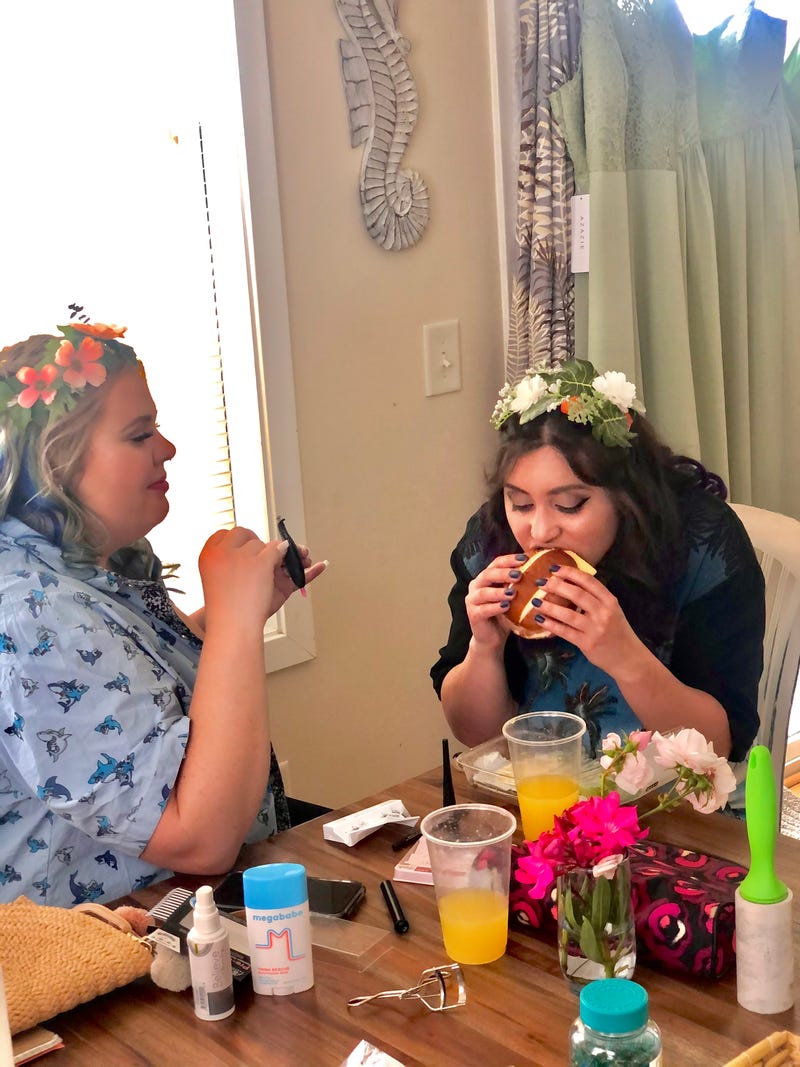 Alanna eats lunch while getting makeup done for the wedding