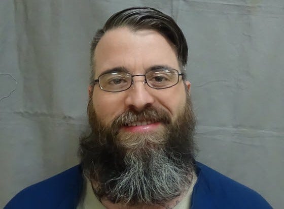 A prisoner is facing first degree murder charges and more in the October death of his cellmate, who was discovered hogtied and stabbed to death under the bed, and for attacking another, authorities announced on Monday.