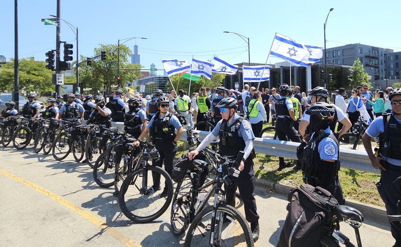 Police in Chicago with protestors near the site of the Democratic National Convention on its opening day Monday.