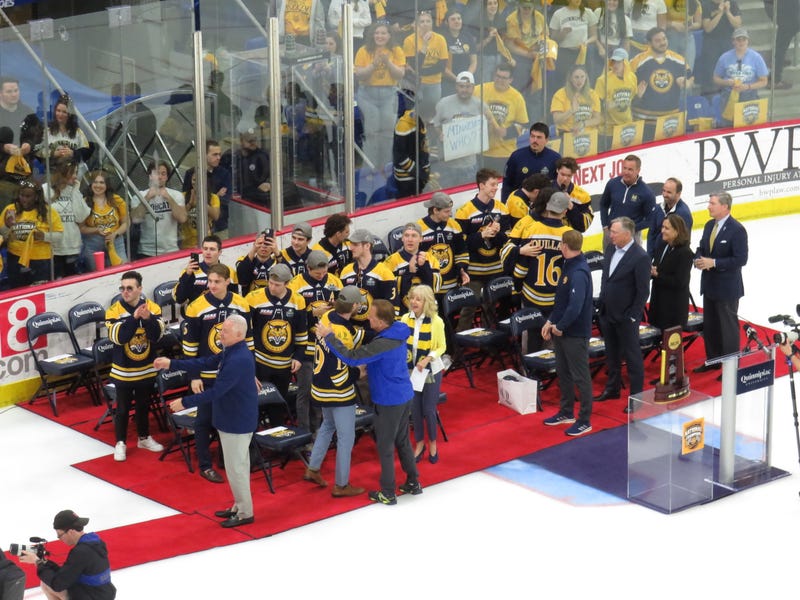 With the NCAA championship trophy on display next to the podium, the Quinnipiac Bobcats celebrate their national championship in Hamden, 4/10/23