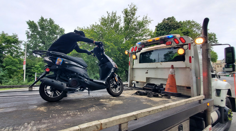 A moped crash on the Cross Island Parkway killed a 15-year-old boy and 19-year-old woman early Saturday morning. Police on the scene removed the vehicle from the crash.