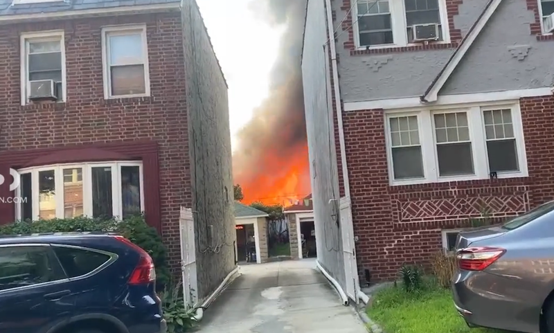 Citizen App footage shows hot orange flames from the rear of a row of attached houses in Queens that burned on Saturday.