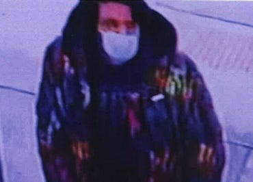 Surveillance footage of man with mask on and multi-colored coat