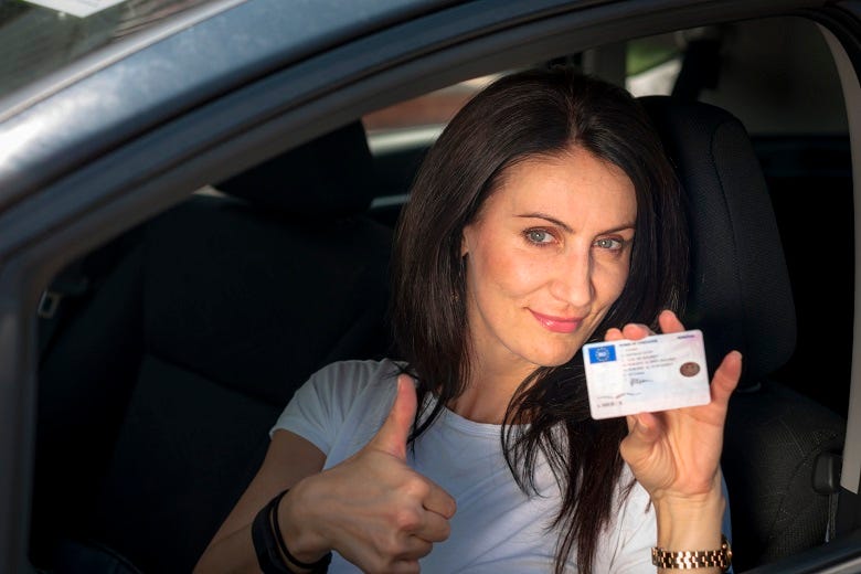 woman holding her I.D.