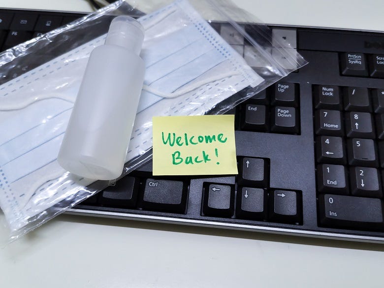 Welcome Back post-it on keyboard