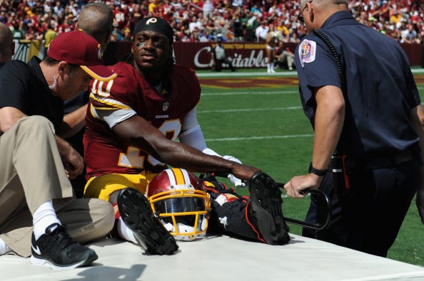 Robert Griffin III is carted off the field in 2014.