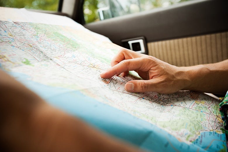 driver looking at map in car