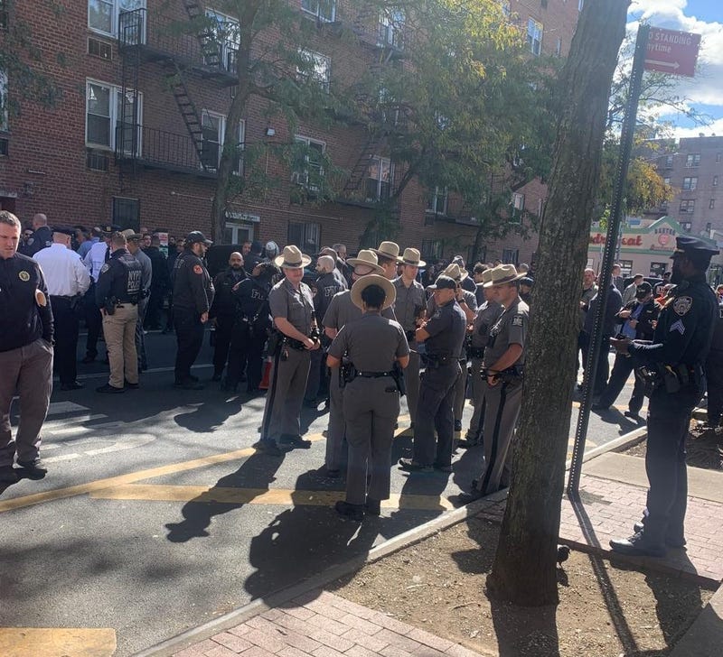 Members of the NYPD and New York State Police are seen near Roosevelt Avenue on Oct. 15, 2024