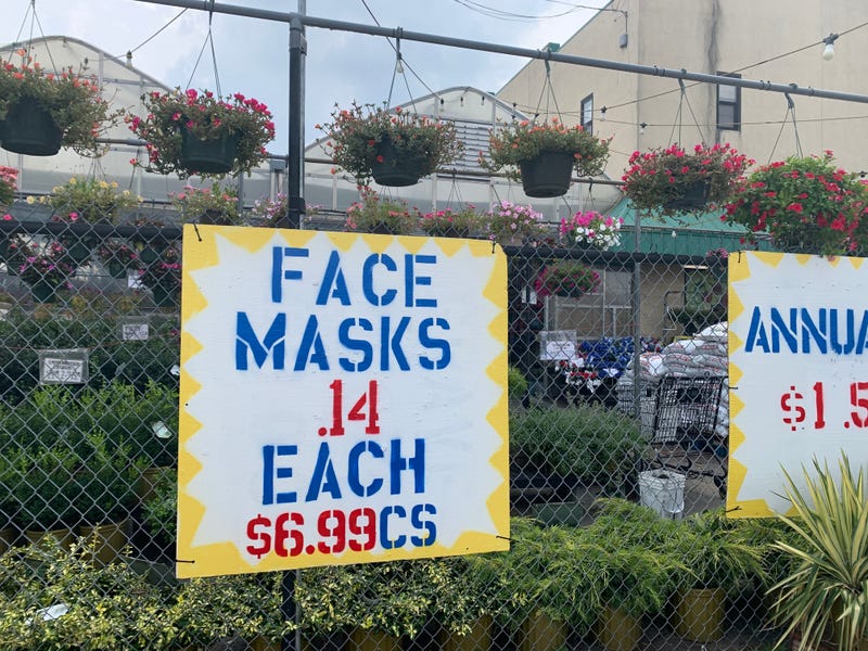 A sign promotes the sale of face masks at R&R Produce and Garden Center in Oxford Circle.