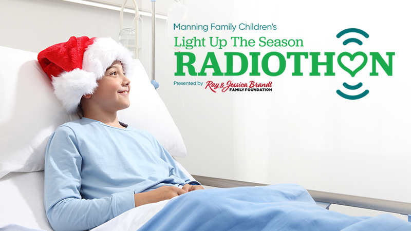 happy child in Santa hat in hospital bed