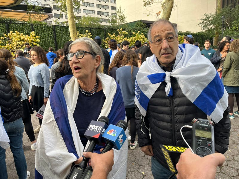 Demonstrators draped Israeli flags around their shoulders at the rally Wednesday morning.