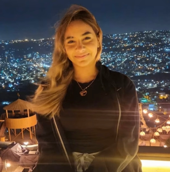 Young girl in front of bright city lights