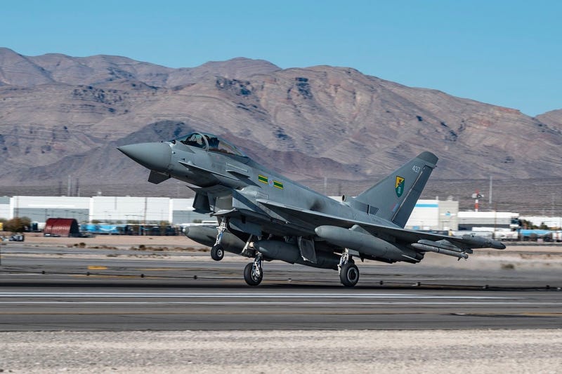 A military aircraft departs Nellis Air Force base