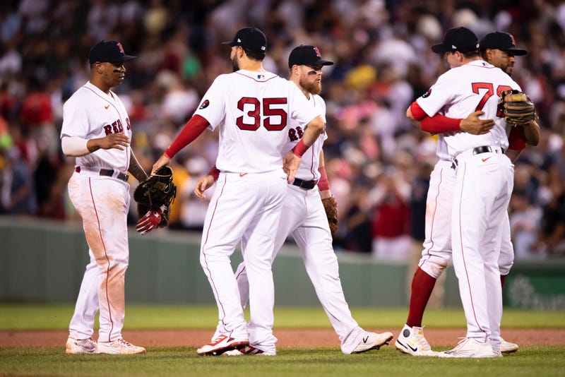 The Red Sox celebrate their 3-0 win over the Yankees on Sunday night.