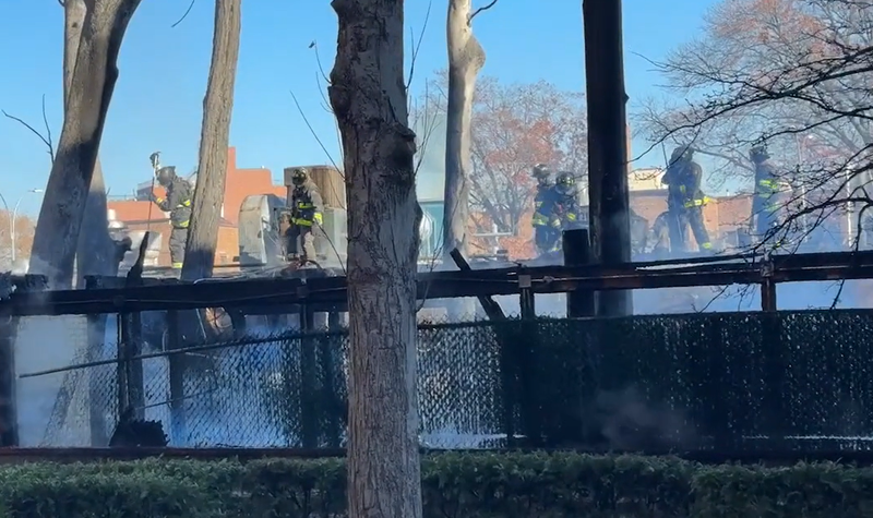 Firefighters battle a commercial building fire in Rego Park Queens.