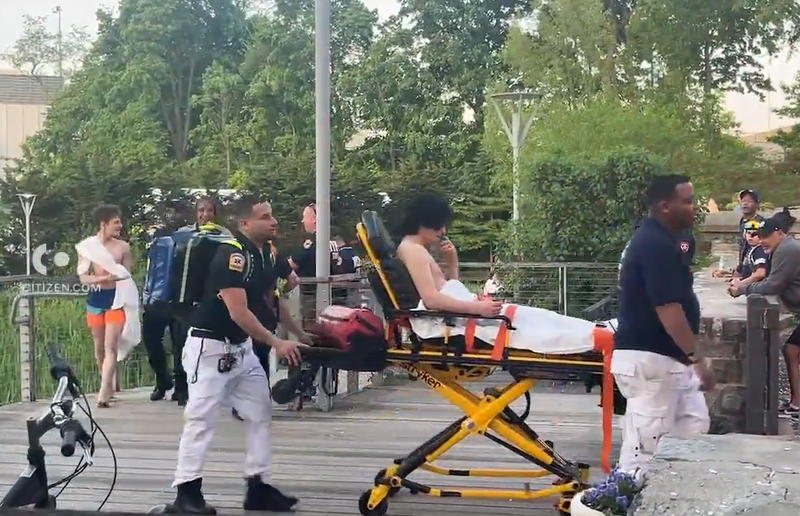 One teen is wheeled out on a stretcher as a second walks with first responders after the rescue