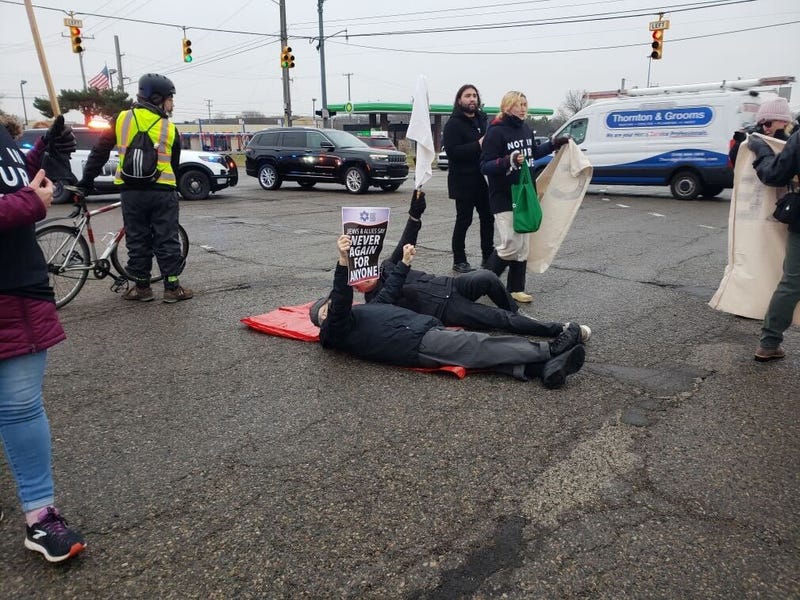 Holocaust survivor lying down in Orchard Lake Road intersection calls for ceasefire in Gaza