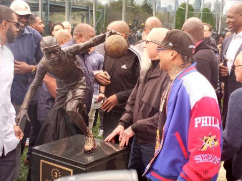 Allen Iverson, right, standing next to his new statue.