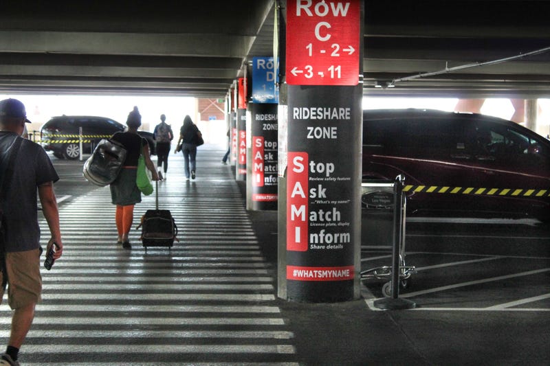 Passengers head to the rideshare area at Reid International Airport