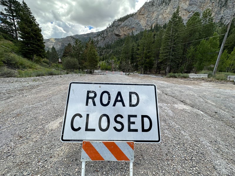 A sign informs drivers that there's no access to the Spring Mountains due to storm damage