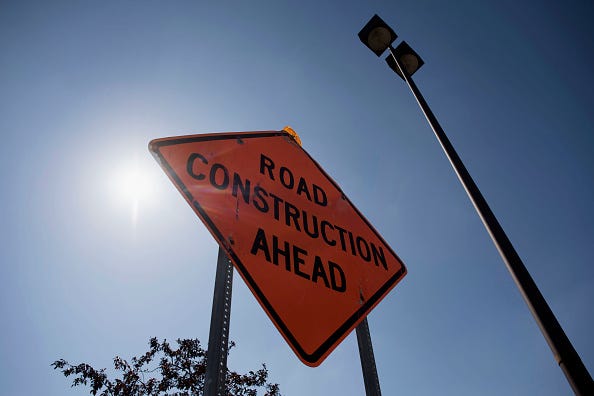 A sign warns drivers of road work ahead