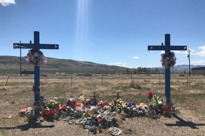 A memorial commemorates lives lost on a Nevada road