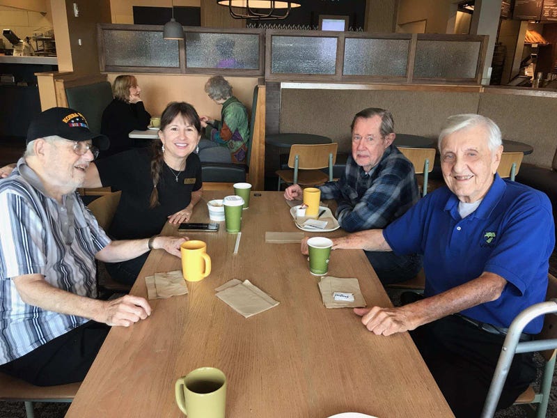 Jacque Axelrad with group of veterans at Panera