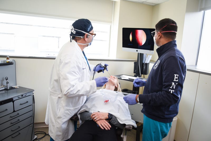 Jefferson Health Dr. Rosen (left), alongside Dr. Glen D. Souza (right), uses an endoscope to place the platelet-rich plasma on the olfactory nerve in the patient's nose. 