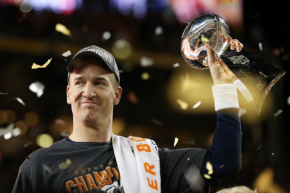 Peyton Manning hoists the Lombardi Trophy with the Broncos