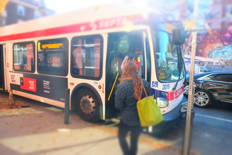 Passengers get on a SEPTA bus.