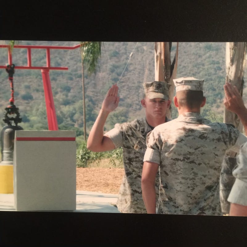 Marine veteran John Shafer is pictured re-enlisting in the Corps while deployed in Afghanistan.