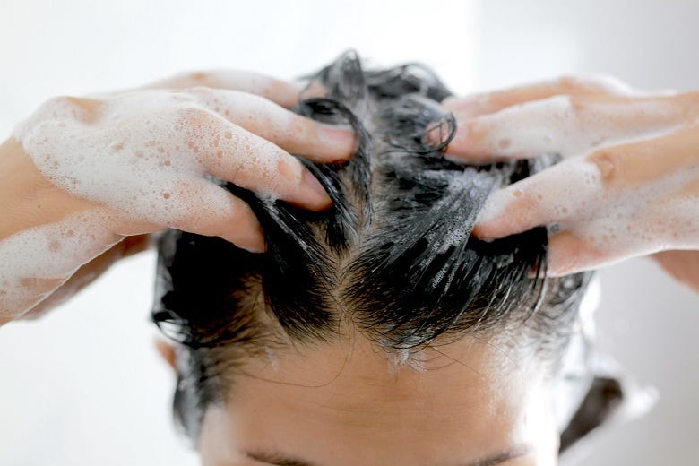woman shampooing hair