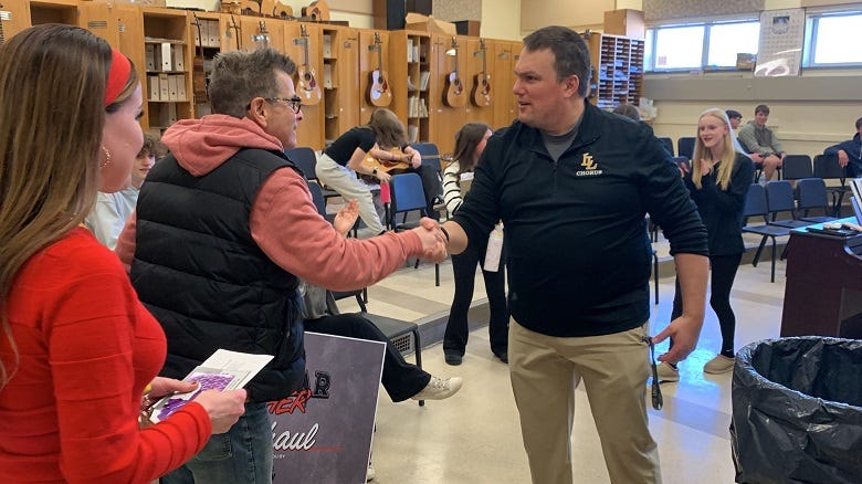Rock shaking Mr. Shaul's hand
