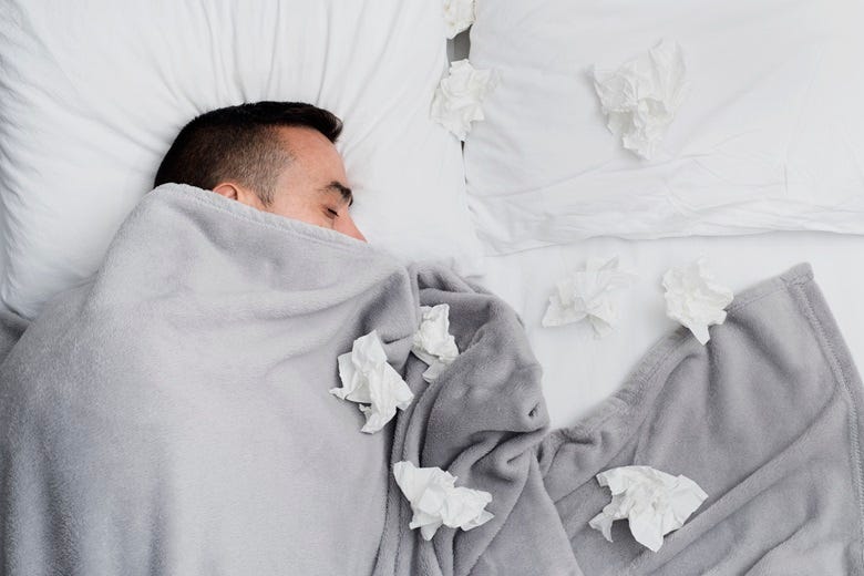 Guy sick in bed