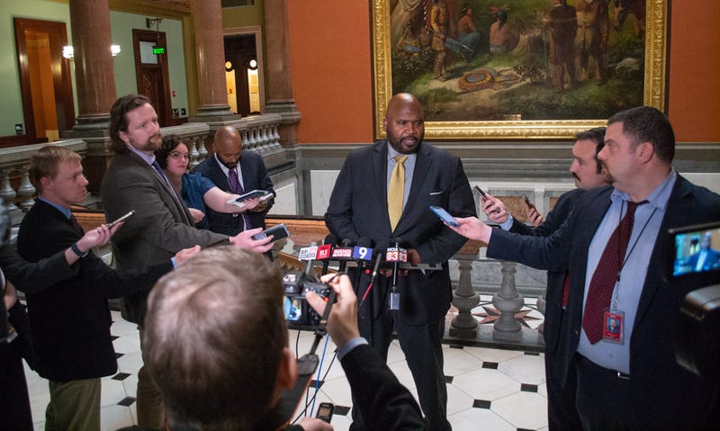 State Sen. Elgie Sims, D-Chicago, talks to reporters in the Capitol rotunda.
