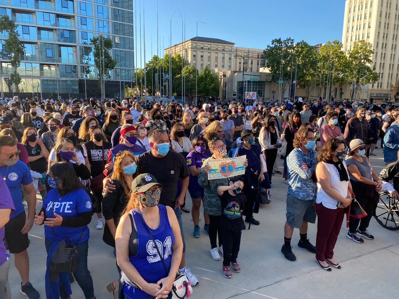 Over a thousand people gather outside San Jose City Hall to mourn the nine lives lost at Wednesday's mass shooting at the Valley Transportation Authority rail yard, May 27, 2021.