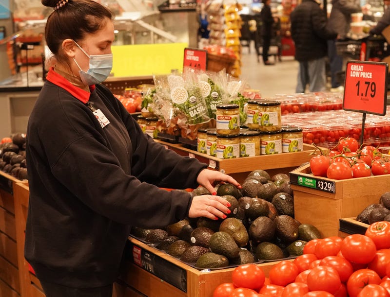 Schnucks worker Bailey Lynn arranges the avocados in the produce section at Schnucks Market in Ladue, Missouri on Friday, February 18, 2022.