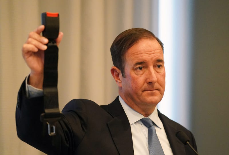 Attorney Michael Haggard displays a $22 seat belt during a press conference announcing a wrongful death lawsuit filed on behalf of the family of Tyre Sampson in St. Louis on Tuesday, April 26, 2022.