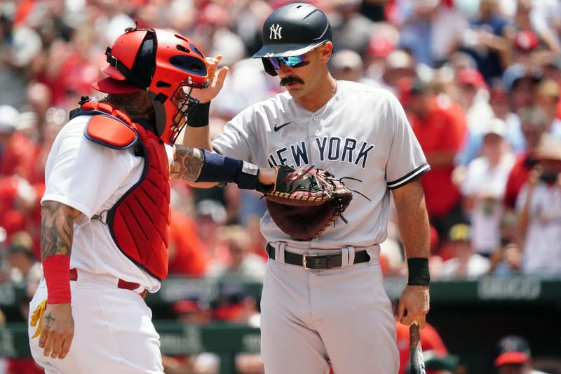 St. Louis Cardinals catcher Yadier Molina taps New York Yankees Matt Carpenter on the stomach as the crowd cheers during his first at bat in the first inning at Busch Stadium in St. Louis on Sunday, August 7, 2022. Carpenter spent 10 years as a member of the Cardinals. 