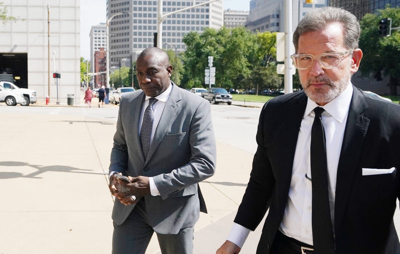 lewis reed walks in downtown st louis with his lawyer