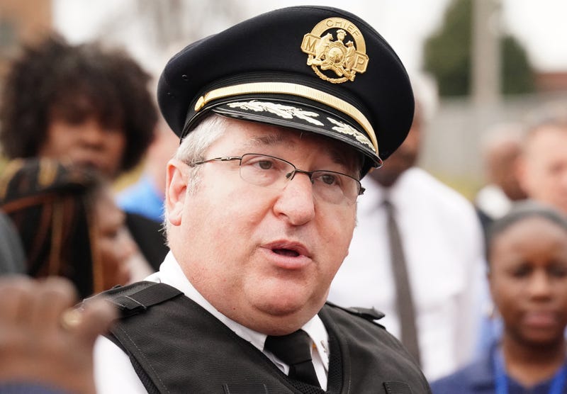close up of michael sack, white man with gray hair and small glasses wearing a police hat
