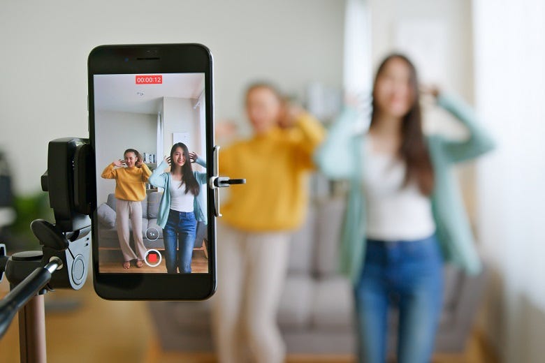 parent taking photo of kids with phone