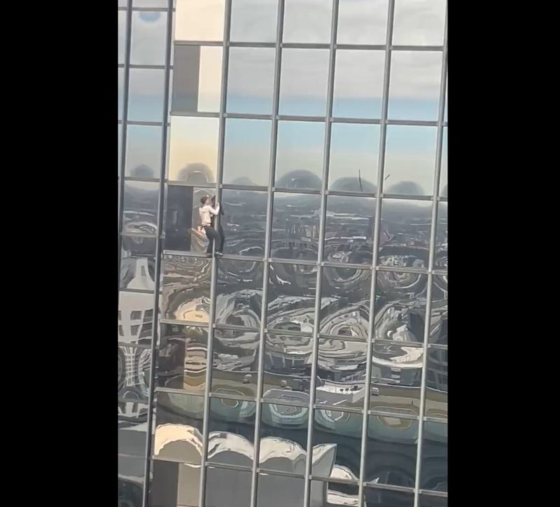 man climbing Accenture Tower