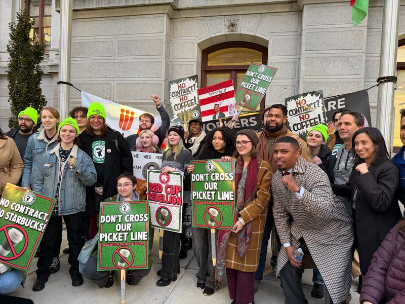 Picketing baristas pose for a photo outside City Hall on Thursday, Nov. 13.