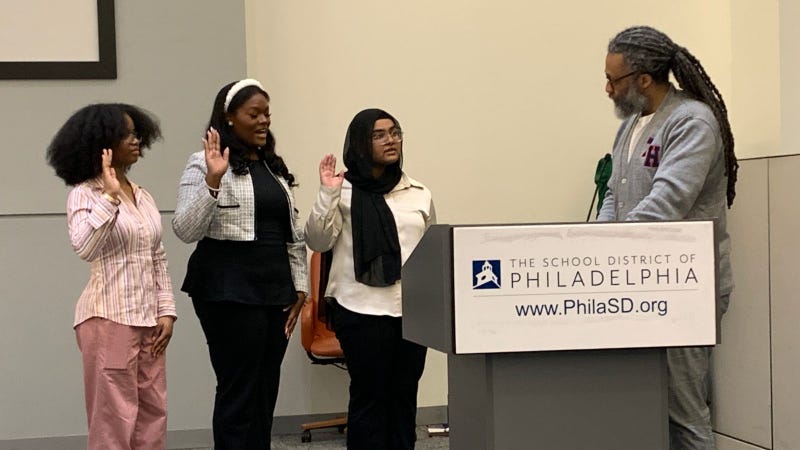New student school board members (L-R) Semira Reyes, Brianni Carter, and Ramisha Karim are sworn in by Philadelphia Board of Education President Reginald Streater.