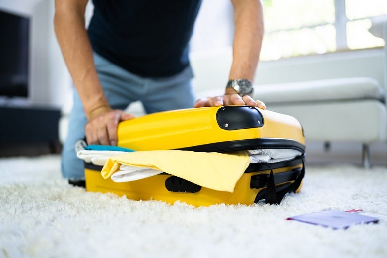 man packing suitcase 